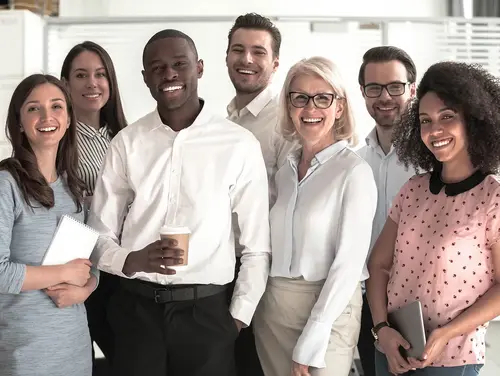 A group of people smiling into the camera
