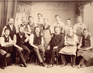 A group of men pose for a black and white photo from 1888