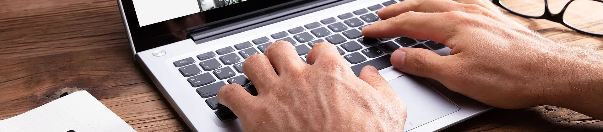 Hands on a laptop keyboard