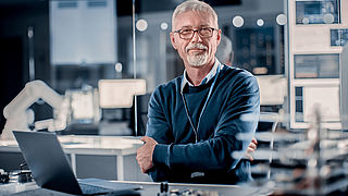 Picture of a man with his laptop at work 