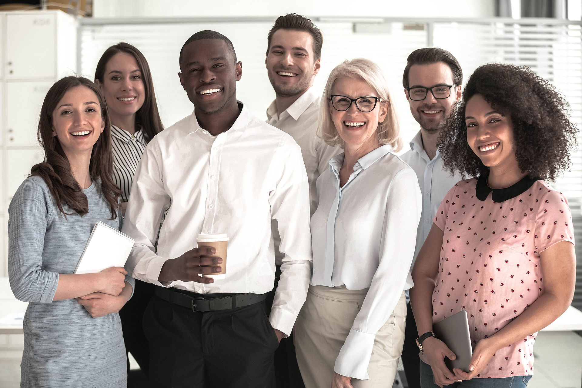 A group of people smiling into the camera